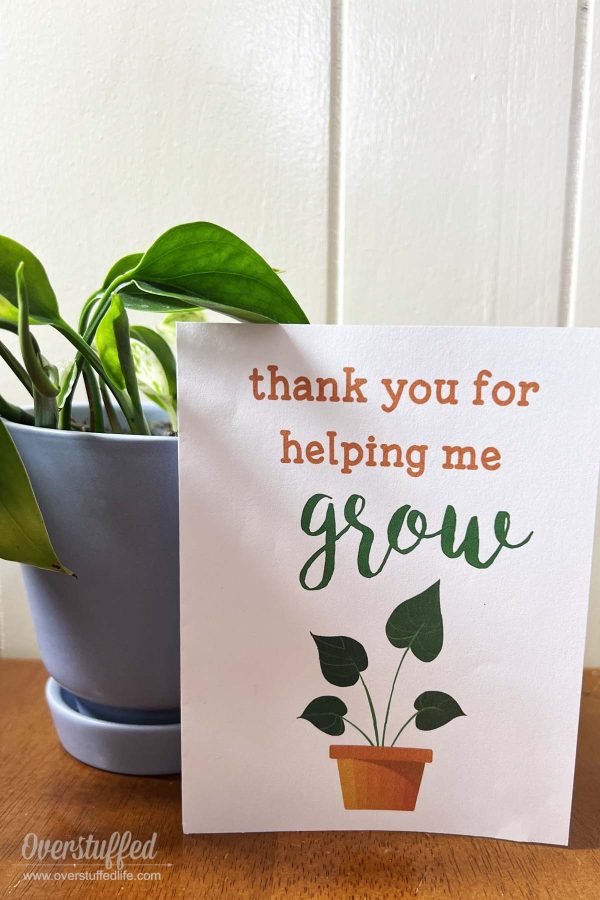 Card that says "Thank you for helping me grow" next to a plant.